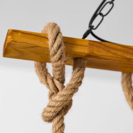 A hemp rope knot pulled tight around the wood crossbar