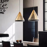 Two cone pendants lit against a dark wall above a low cabinet