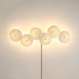 Six discs in a horizontal row, lit, the cord dropping from the center