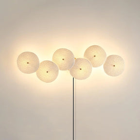 Six discs in a horizontal row, lit, the cord dropping from the center