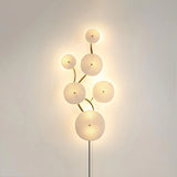The vertical disc cluster glowing on a beige wall, the cord below