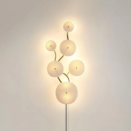 The vertical disc cluster glowing on a beige wall, the cord below