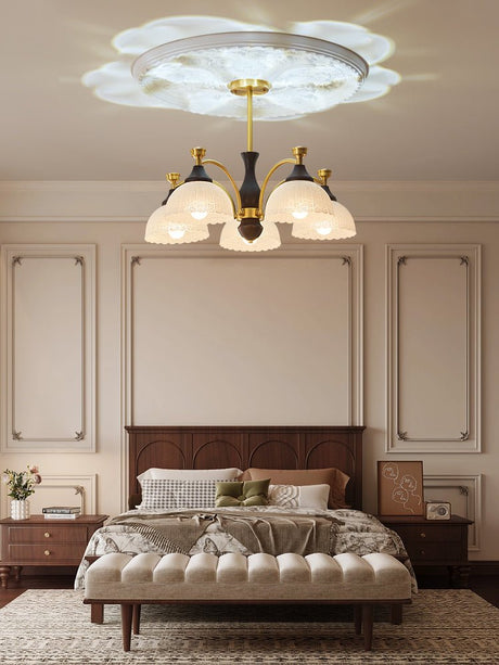 Domes lit above a made bed in a room with wall panels behind it