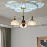 The fitting lit beside a long curtain above a wood chest of drawers