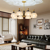 Chandelier lit in a living room above a dark leather sofa and table