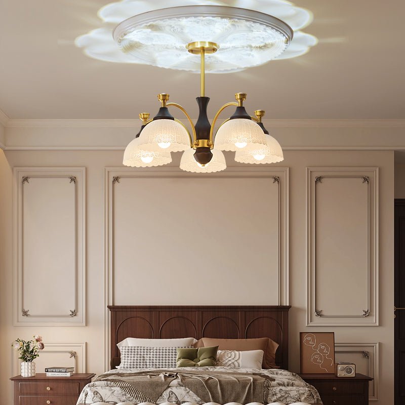 The domes lit in a pale bedroom above a bed and two nightstands