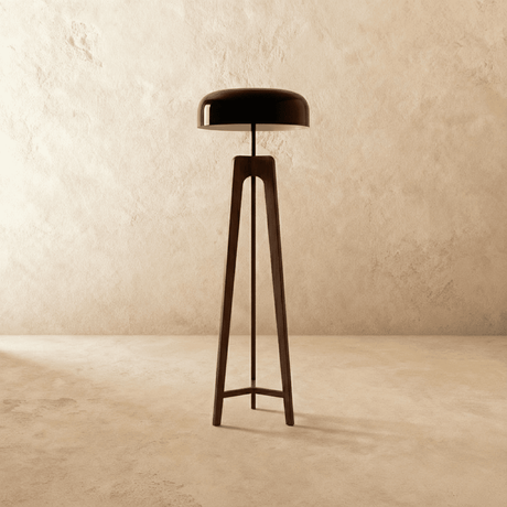 The dark wood tripod seen at an angle, the three legs meeting under the dome