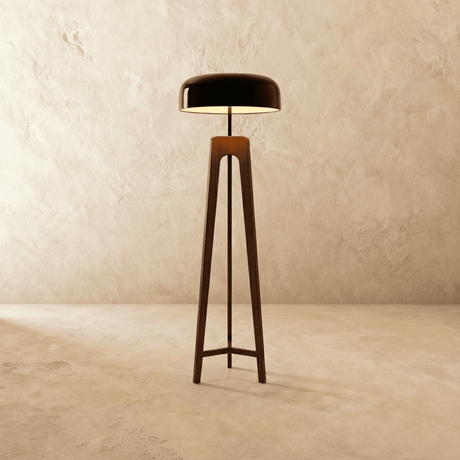 A dark wood tripod carrying a wide black dome shade above three splayed legs
