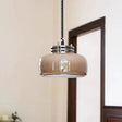 The amber glass dome lit on a twisted cord beside a wooden doorway