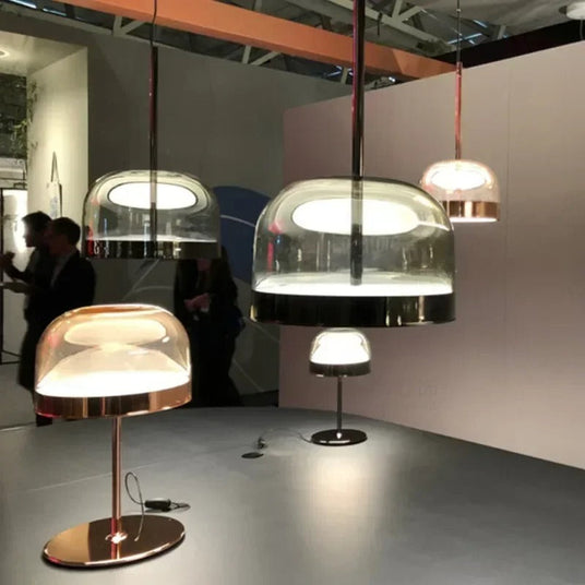 Tinted glass domes lit above a dining table