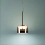 Tinted glass dome hung against a pale green wall