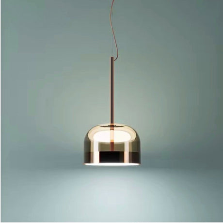 Tinted glass dome hung against a pale green wall