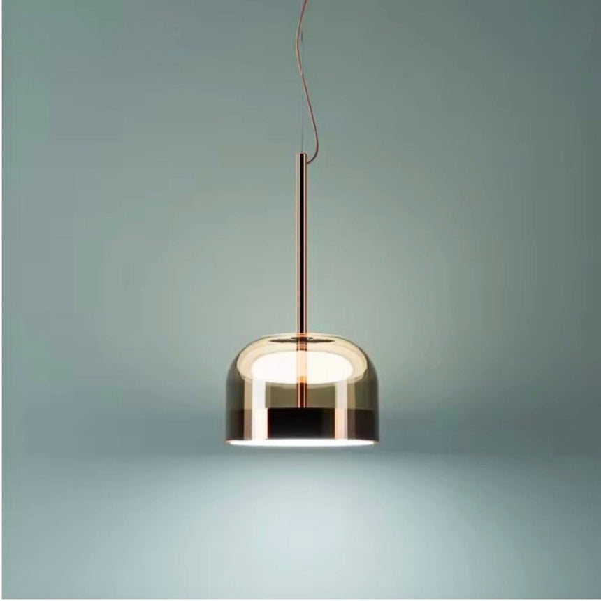 Tinted glass dome hung against a pale green wall