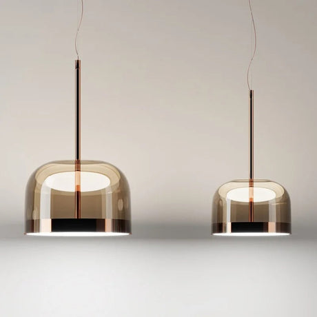 Dome pendant light in tinted glass hung in a row above a counter