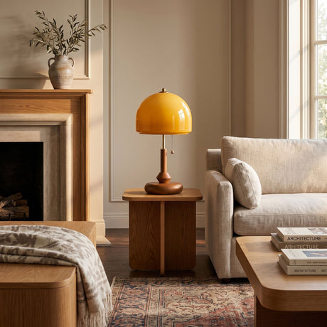 Amber dome table lamp lit on a wooden side table beside a sofa