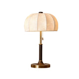 Segmented dome lamp with a dark stem and a brass foot, plain ground