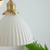 Close view of the knurled brass socket and the pleated dome
