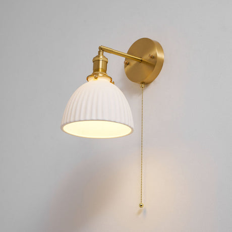The dome lit on a pale background, the brass arm angled down
