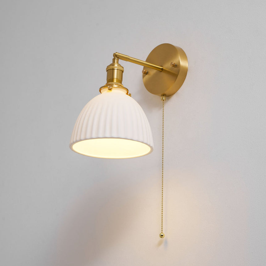 The dome lit on a pale background, the brass arm angled down