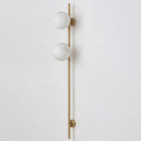 The brass version with two stone globes on a white background