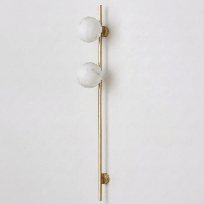 The brass version with two stone globes on a white background