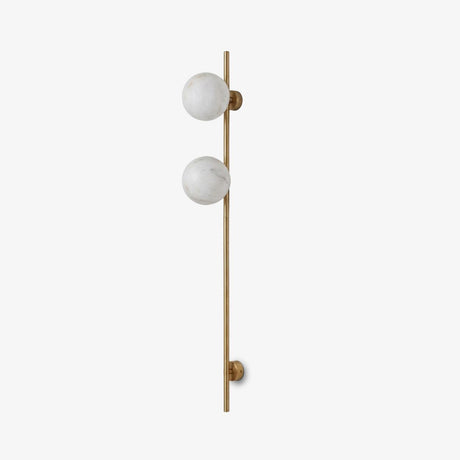 Tall slim rod wall sconce with two round stone globes on a pale wall