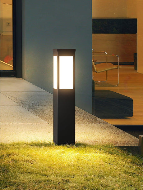 One lit at the edge of a lawn beside a lit entry and a handrail