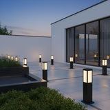 A run lit along a paved terrace beside a house with glass doors