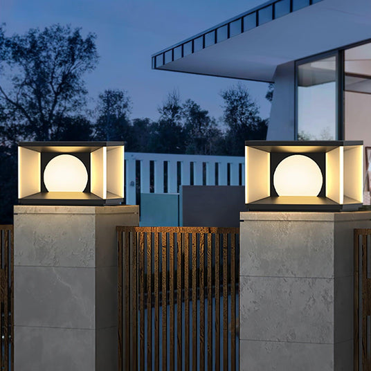 A row of lit cubes along pillars above a dark slatted boundary fence