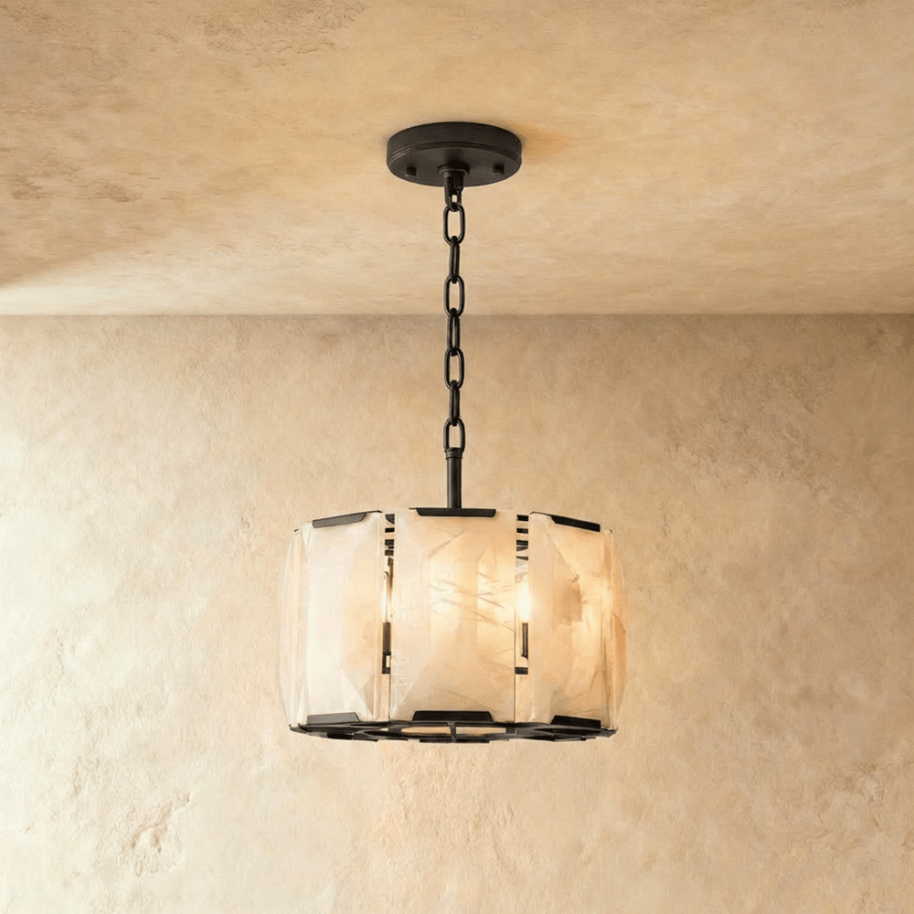 A drum of alabaster panels in a black frame on a short chain
