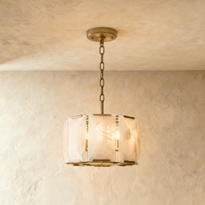 A drum of alabaster panels in a brass frame on a short chain