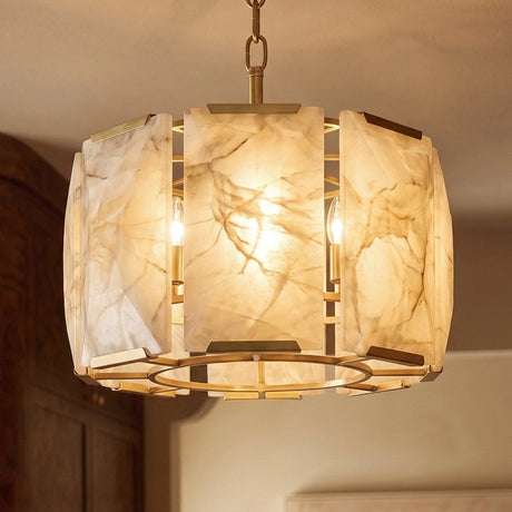 The brass framed drum lit, seen close against a pale wall
