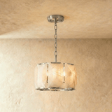 A drum of alabaster panels held in a polished silver frame