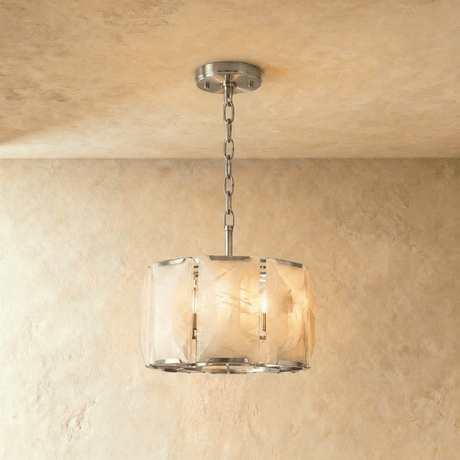 A drum of alabaster panels held in a polished silver frame