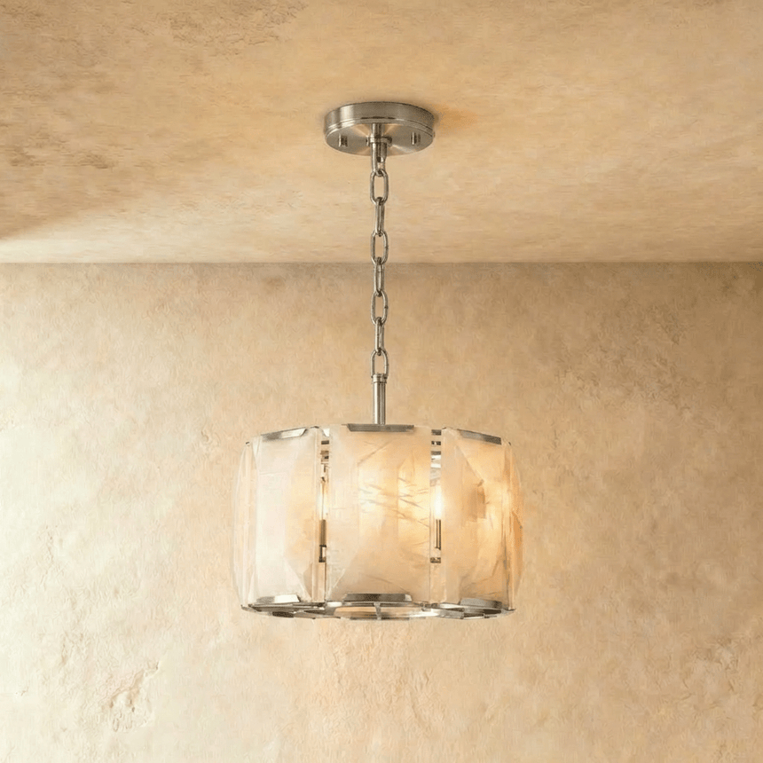 A drum of alabaster panels held in a polished silver frame