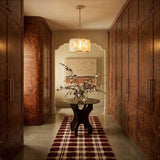 A lit drum in a hallway between timber wardrobes above a rug