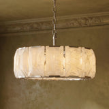 The lit drum seen against a molded cornice on a green wall