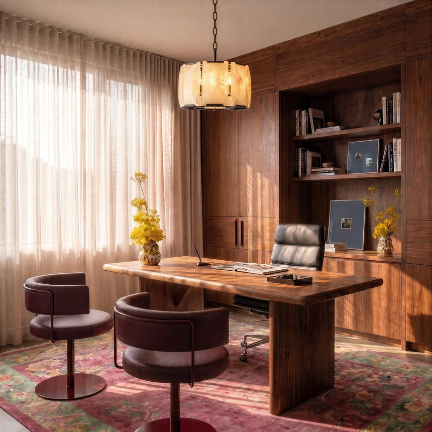 A lit stone drum above a timber desk and two chairs in an office