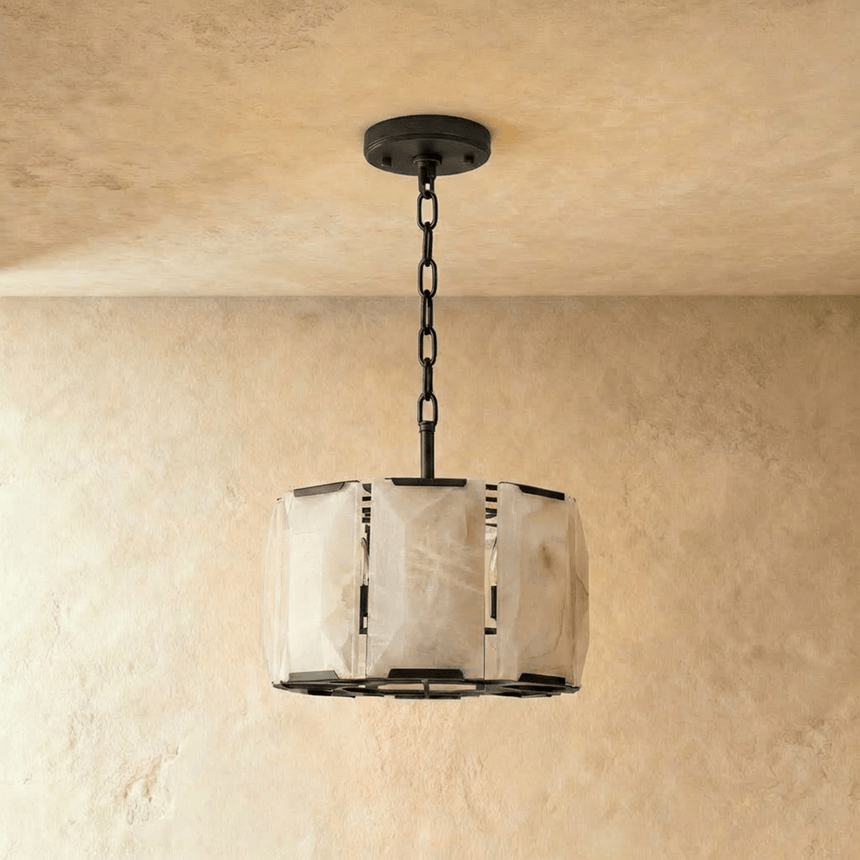 A taller alabaster drum in a black frame hung from a ceiling plate