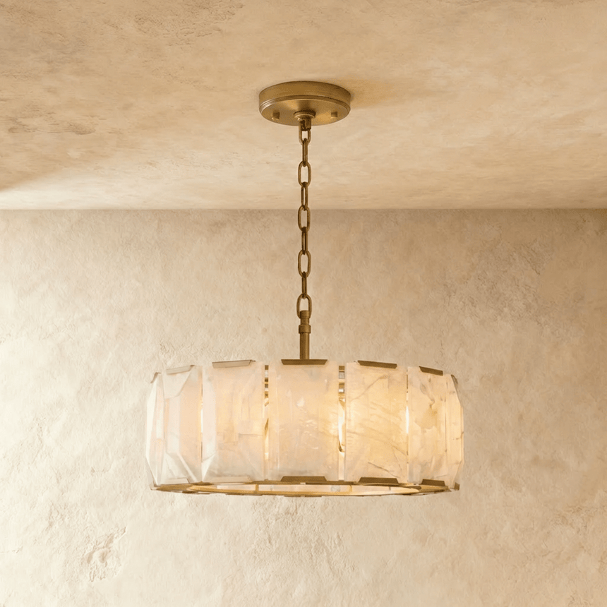 A taller alabaster drum in a brass frame below a ceiling plate