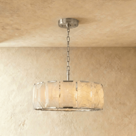A taller alabaster drum in a silver frame on a slim chain