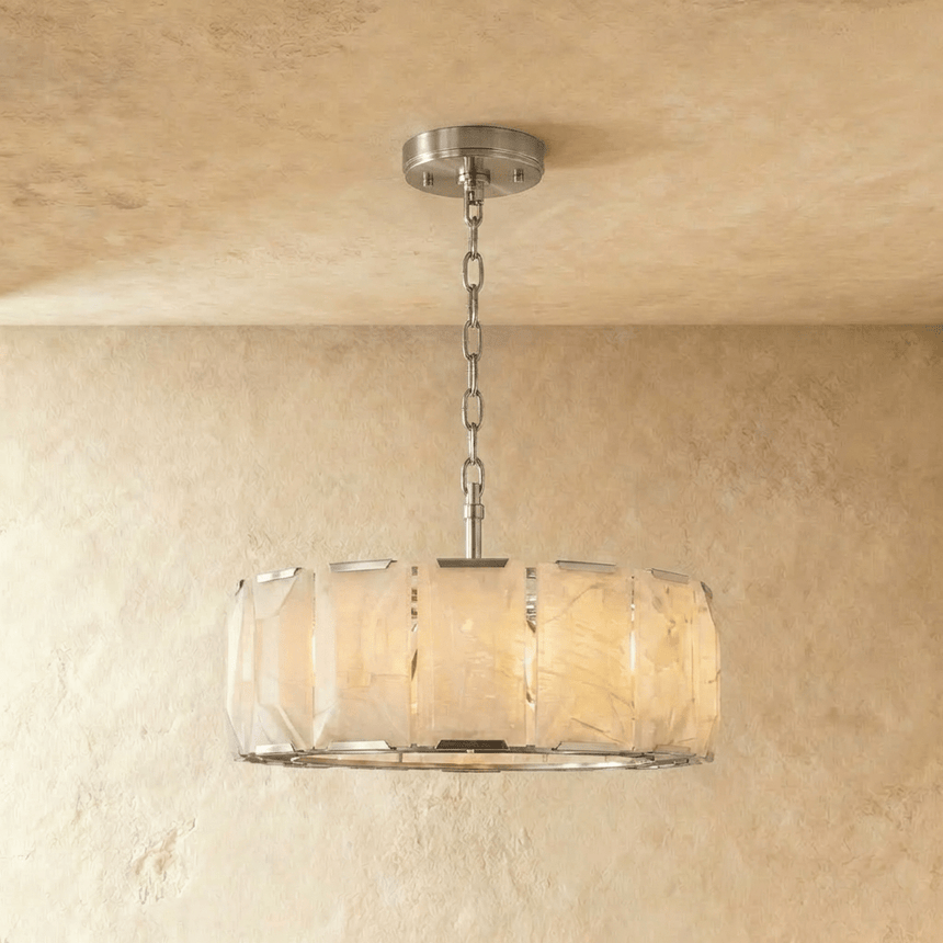 A taller alabaster drum in a silver frame on a slim chain