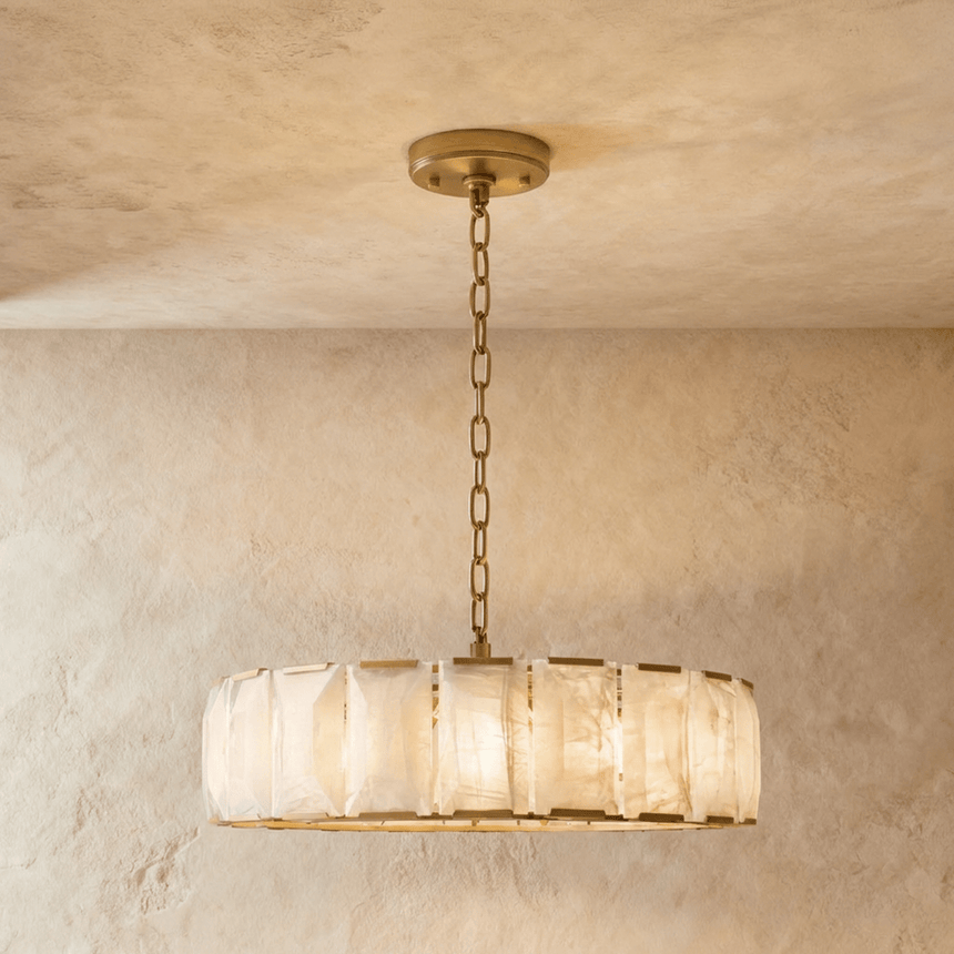 A wide drum of stone panels held in a brass frame and chain