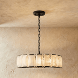 The widest drum in a black frame hung on a chain from a plate