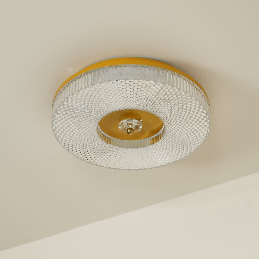 Ribbed drum ceiling light with a brass rim seen at an angle