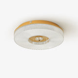 Ribbed drum ceiling light with a brass rim seen from below