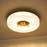 Lit ribbed drum ceiling light seen close against a warm ceiling