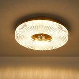 Lit ribbed drum ceiling light with the brass center in view