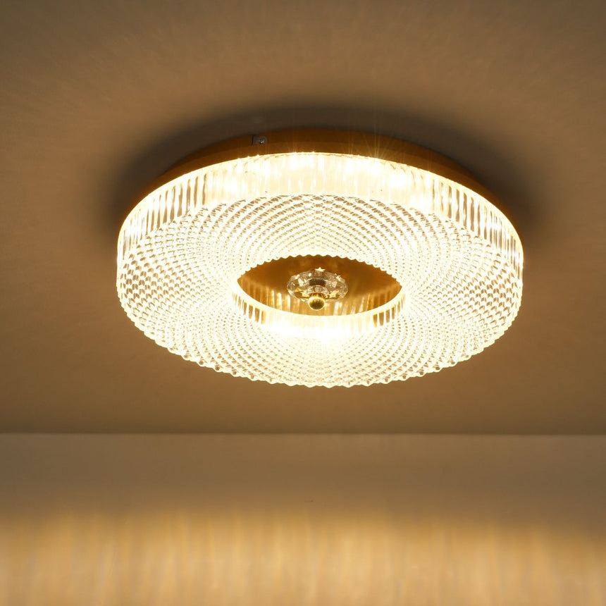 Lit ribbed drum ceiling light with the brass center in view