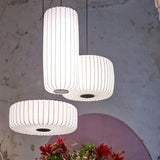 Three ribbed silk shades grouped above a round table